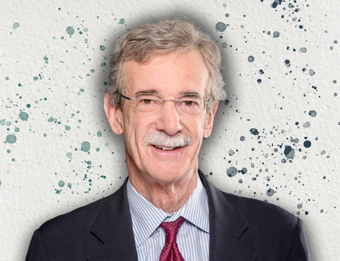 Headshot of AG Brian Frosh in a black suit and red tie, over an offwhite background with green and blue spatter